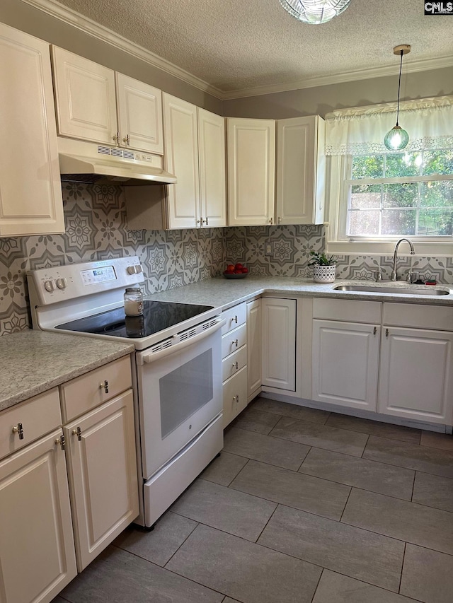 2324 Morningside Dr, West Columbia, SC 29169 - kitchen featuring electric range, under cabinet range hood, a textured ceiling, light countertops, and decorative backsplash