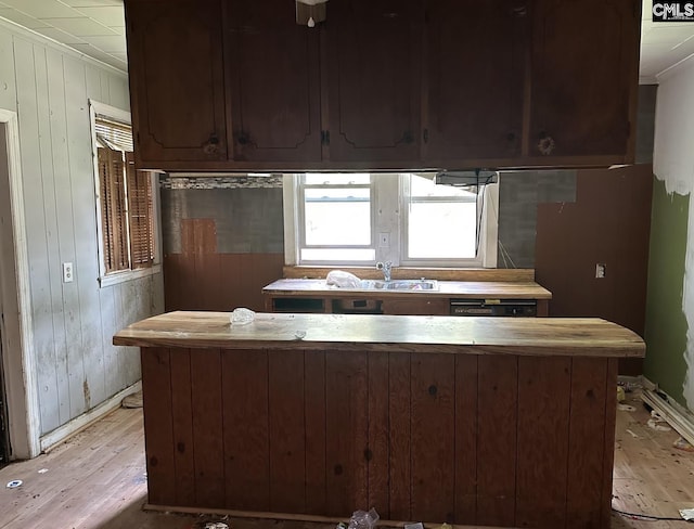 2601 Myrtle St, Newberry, SC 29108 - kitchen with light wood-style flooring, wooden walls, and crown molding