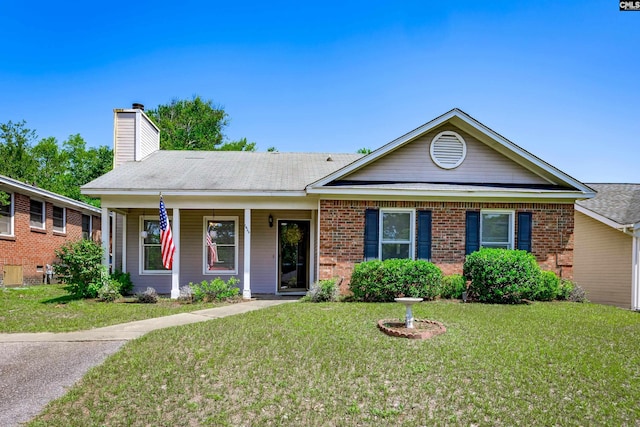 1426 B Ave, West Columbia, SC 29169 - single story home featuring a front lawn, a chimney, brick siding, and a porch
