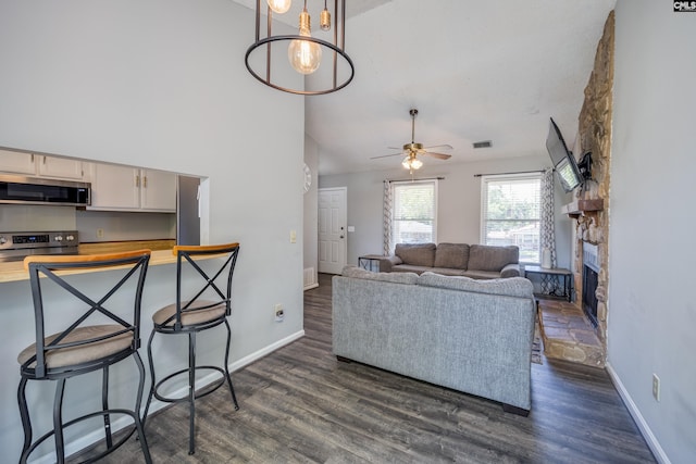 1426 B Ave, West Columbia, SC 29169 - living room with dark wood finished floors, ceiling fan, a fireplace, and high vaulted ceiling