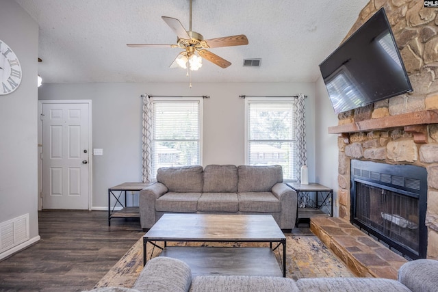 1426 B Ave, West Columbia, SC 29169 - living area featuring a ceiling fan, a textured ceiling, wood finished floors, and a stone fireplace