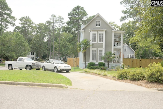 5 Eastpine Ct, Columbia, SC 29212 - view of front facade featuring a balcony, concrete driveway, and view of wooded area