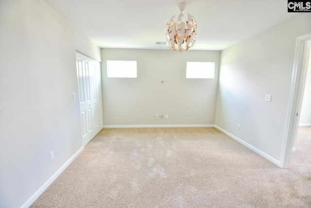 608 Cheehaw Ave, West Columbia, SC 29170 - empty room with light colored carpet, plenty of natural light, and a chandelier