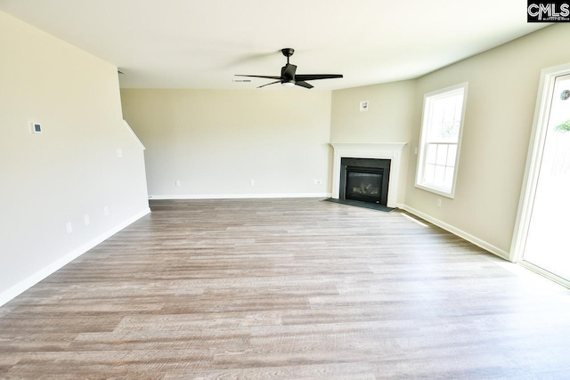 608 Cheehaw Ave, West Columbia, SC 29170 - unfurnished living room featuring ceiling fan, a fireplace with flush hearth, and wood finished floors