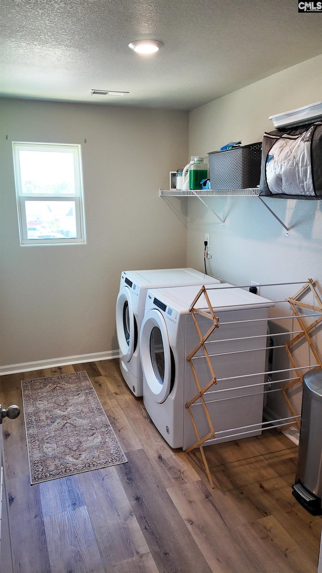 255 Common Reed Dr, Gilbert, SC 29054 - laundry area with washer and dryer, wood finished floors, and a textured ceiling