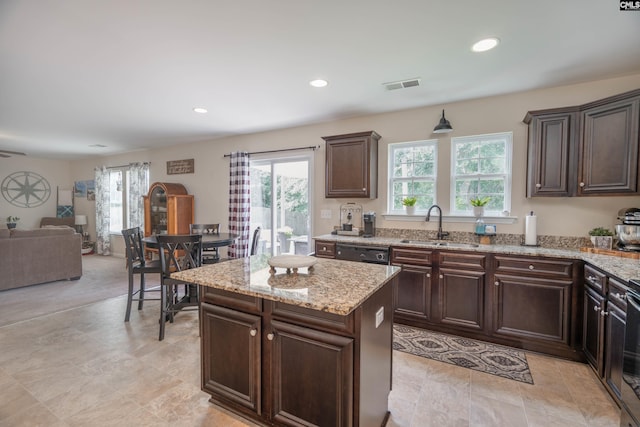 611 Colony Lakes Dr, Lexington, SC 29073 - kitchen with dishwasher, dark brown cabinets, light stone counters, recessed lighting, and open floor plan