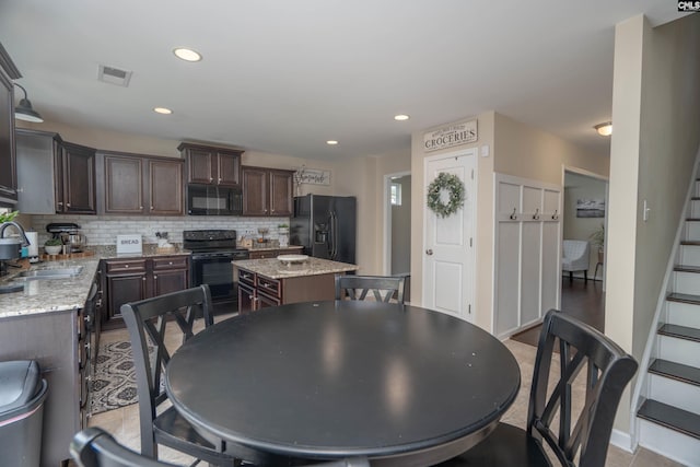611 Colony Lakes Dr, Lexington, SC 29073 - kitchen with black appliances, a kitchen island, dark brown cabinetry, tasteful backsplash, and recessed lighting
