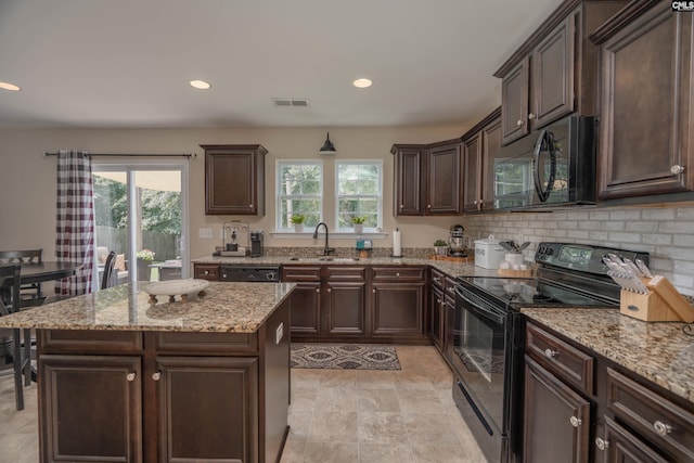 611 Colony Lakes Dr, Lexington, SC 29073 - kitchen featuring black appliances, dark brown cabinetry, light stone countertops, recessed lighting, and a kitchen island