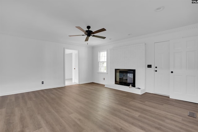 455 Harleston Rd, Irmo, SC 29063 - unfurnished living room featuring ceiling fan, wood finished floors, ornamental molding, and a brick fireplace