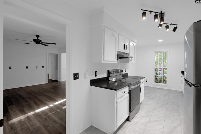 455 Harleston Rd, Irmo, SC 29063 - kitchen featuring electric range, under cabinet range hood, dark countertops, freestanding refrigerator, and white cabinets