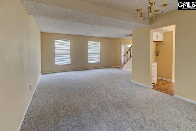 125 Durham Creek Ct, Columbia, SC 29229 - empty room featuring carpet floors, a chandelier, and stairway