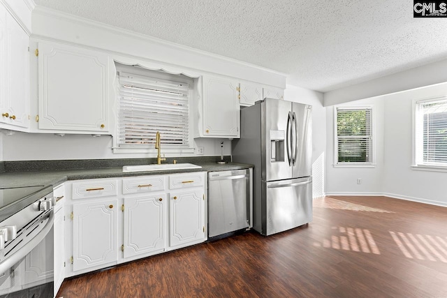 9829 Highgate Rd, Columbia, SC 29223 - kitchen featuring stainless steel appliances, dark countertops, dark wood-style floors, white cabinetry, and a textured ceiling