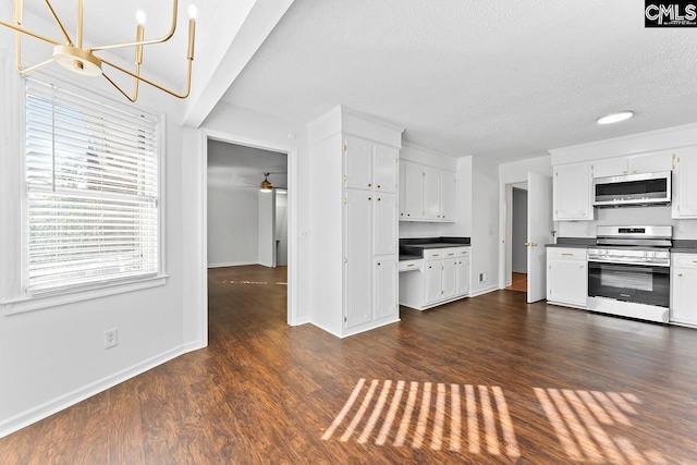 9829 Highgate Rd, Columbia, SC 29223 - kitchen featuring appliances with stainless steel finishes, dark countertops, white cabinetry, a textured ceiling, and dark wood-style flooring