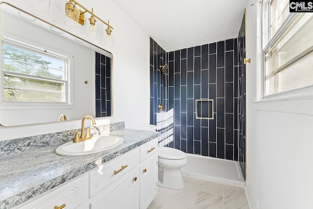 9829 Highgate Rd, Columbia, SC 29223 - full bathroom with vanity, a tile shower, and marble look tile flooring