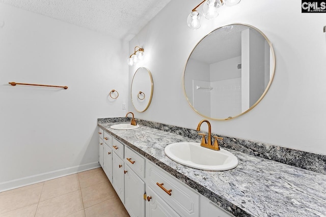 9829 Highgate Rd, Columbia, SC 29223 - bathroom featuring a textured ceiling, double vanity, and tile patterned floors