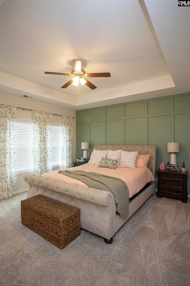 140 Green Ivy Ct, Camden, SC 29020 - carpeted bedroom with a decorative wall, a tray ceiling, and ceiling fan