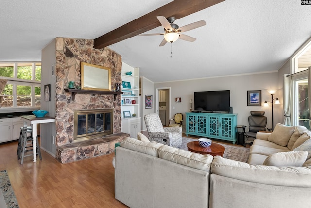 732 Nichols Ct, Leesville, SC 29070 - living area with light wood finished floors, a textured ceiling, ceiling fan, and a stone fireplace