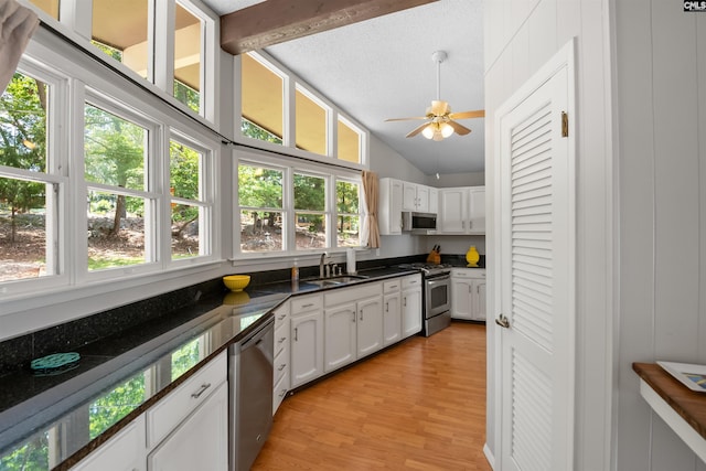 732 Nichols Ct, Leesville, SC 29070 - kitchen with appliances with stainless steel finishes, lofted ceiling, plenty of natural light, light wood-type flooring, and white cabinetry