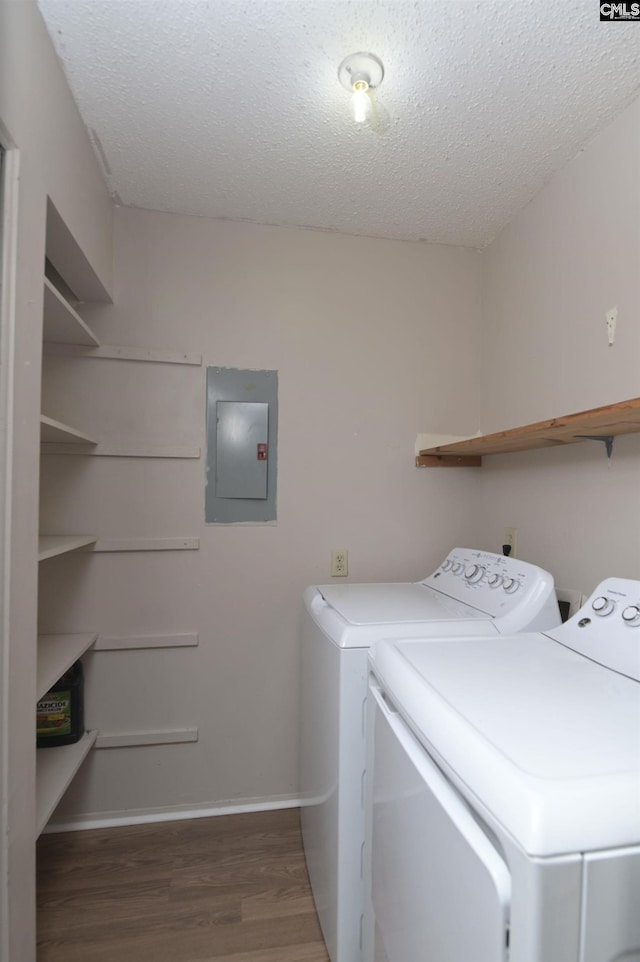 207 Weddell St Unit 2-D, Columbia, SC 29223 - washroom with electric panel, washer and clothes dryer, wood finished floors, and a textured ceiling