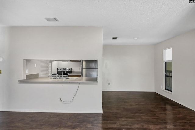 207 Weddell St Unit 2-D, Columbia, SC 29223 - kitchen featuring stainless steel appliances, wood finished floors, and a textured ceiling