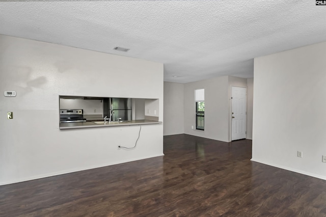 207 Weddell St Unit 2-D, Columbia, SC 29223 - unfurnished living room with dark wood-type flooring and a textured ceiling