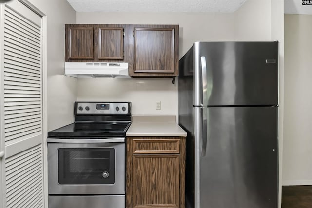 207 Weddell St Unit 2-D, Columbia, SC 29223 - kitchen featuring appliances with stainless steel finishes, under cabinet range hood, light countertops, and a textured ceiling