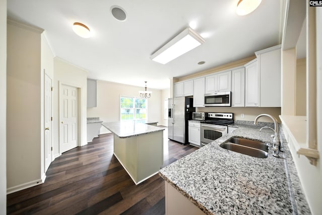 112 Rivendell Dr, Lexington, SC 29073 - kitchen featuring appliances with stainless steel finishes, a center island, dark wood finished floors, light stone countertops, and crown molding