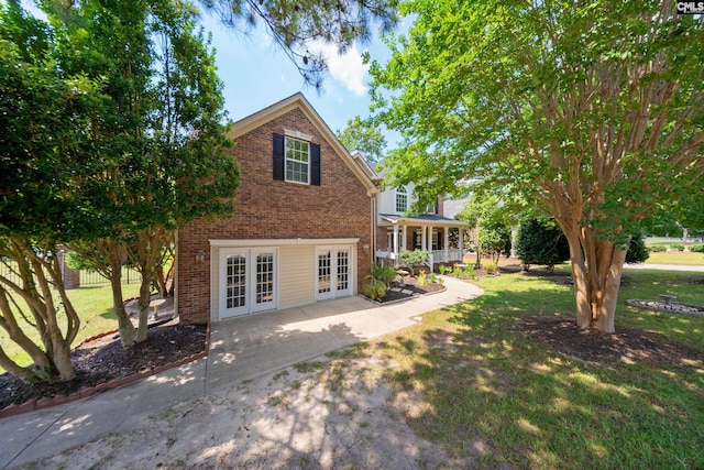 112 Rivendell Dr, Lexington, SC 29073 - back of property featuring french doors, brick siding, and a yard
