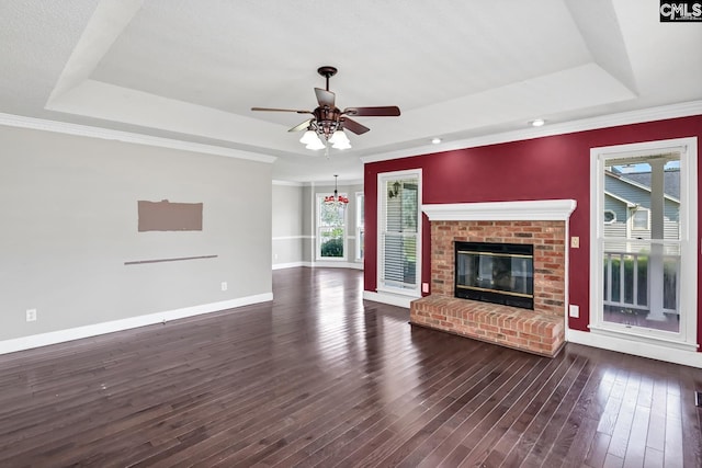 263 Sausage Ln, West Columbia, SC 29170 - unfurnished living room with a tray ceiling, dark wood finished floors, a ceiling fan, a brick fireplace, and ornamental molding