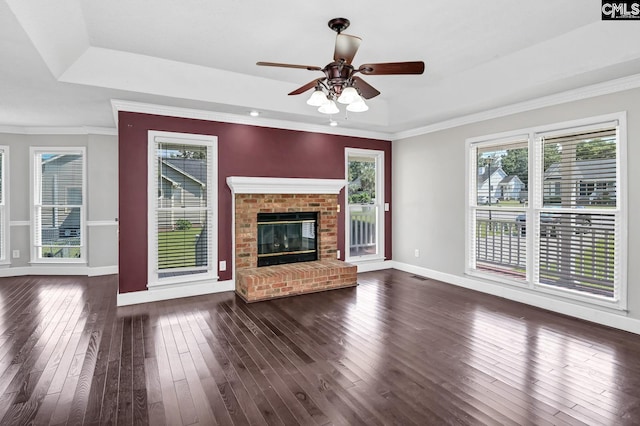 263 Sausage Ln, West Columbia, SC 29170 - unfurnished living room with a raised ceiling, dark wood finished floors, a ceiling fan, a brick fireplace, and ornamental molding