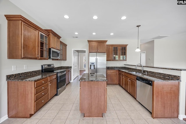 267 Caedmons Creek Dr, Irmo, SC 29063 - kitchen with stainless steel appliances, a peninsula, a kitchen island, dark stone counters, and recessed lighting