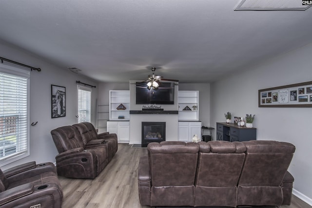 450 Laurel Mist Ln, West Columbia, SC 29170 - living area with a ceiling fan, wood finished floors, and a glass covered fireplace