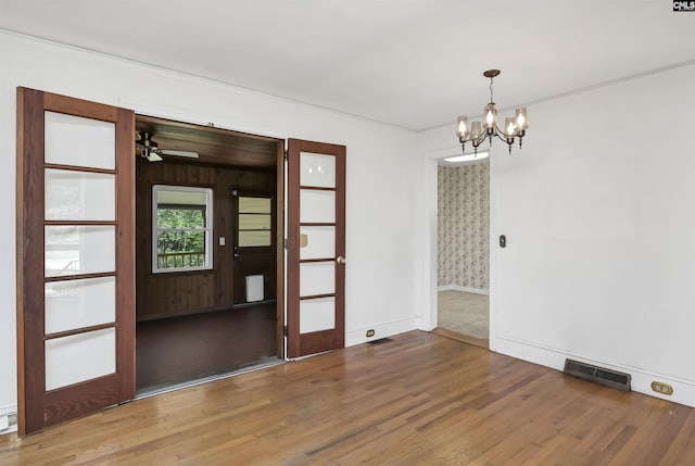 4614 Briarfield Rd, Columbia, SC 29206 - unfurnished room with wood finished floors, a chandelier, ceiling fan, and crown molding