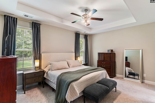 2203 Newberry Landing Cir, Newberry, SC 29108 - bedroom with a raised ceiling, light colored carpet, multiple windows, and a ceiling fan