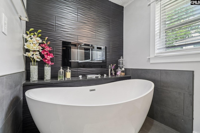 2032 Pinewood St, Cayce, SC 29033 - bathroom with tile walls, a freestanding tub, and wainscoting