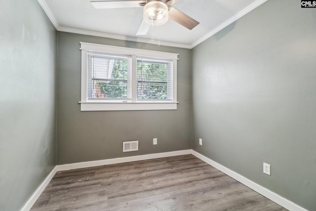 2032 Pinewood St, Cayce, SC 29033 - spare room featuring ornamental molding, a ceiling fan, and wood finished floors