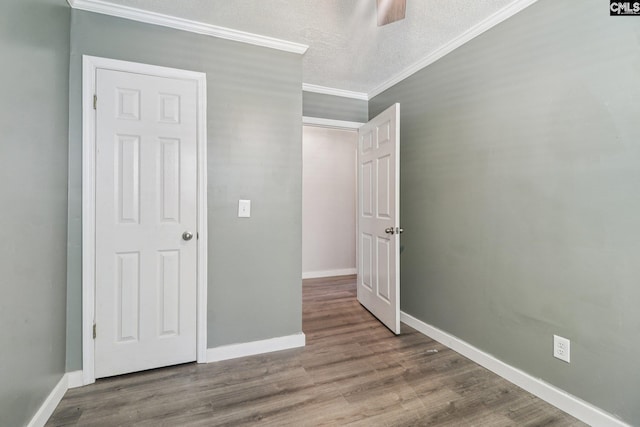 2032 Pinewood St, Cayce, SC 29033 - unfurnished bedroom featuring ornamental molding, wood finished floors, a textured ceiling, and a ceiling fan