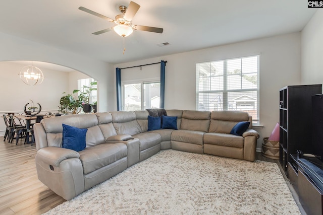 1056 Turtle Stone Rd, Blythewood, SC 29016 - living area featuring a chandelier, arched walkways, plenty of natural light, and wood finished floors