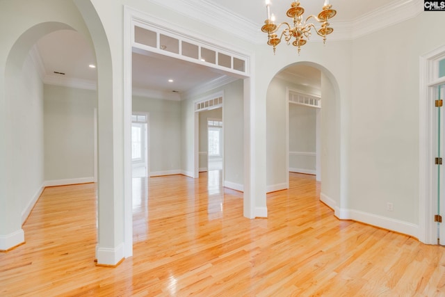 201 Arcadia Lakes Dr, Columbia, SC 29206 - unfurnished room featuring ornamental molding, light wood-style floors, arched walkways, and a chandelier