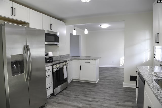 960 Curtis St, Columbia, SC 29210 - kitchen with stainless steel appliances, a peninsula, white cabinets, dark wood-style flooring, and crown molding