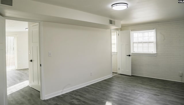 960 Curtis St, Columbia, SC 29210 - spare room featuring dark wood finished floors and brick wall
