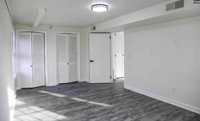 960 Curtis St, Columbia, SC 29210 - unfurnished bedroom featuring two closets and dark wood-style floors