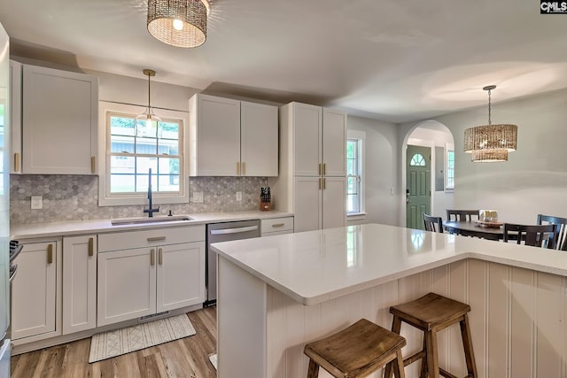 5404 Fairview Rd, Batesburg, SC 29006 - kitchen featuring dishwasher, arched walkways, light countertops, light wood finished floors, and a breakfast bar area
