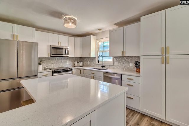 5404 Fairview Rd, Batesburg, SC 29006 - kitchen with stainless steel appliances, backsplash, light stone counters, and hanging light fixtures