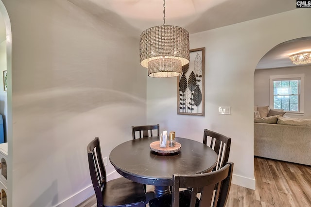 5404 Fairview Rd, Batesburg, SC 29006 - dining room with arched walkways, a chandelier, and light wood-style flooring