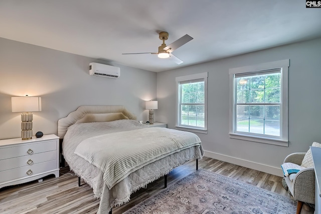 5404 Fairview Rd, Batesburg, SC 29006 - bedroom with an AC wall unit, light wood-type flooring, and ceiling fan