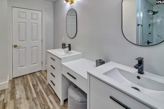 5404 Fairview Rd, Batesburg, SC 29006 - full bathroom featuring two vanities, a stall shower, and wood finished floors