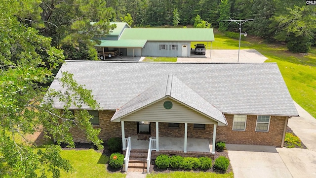 5404 Fairview Rd, Batesburg, SC 29006 - view of front of home featuring a porch, a front lawn, concrete driveway, and brick siding