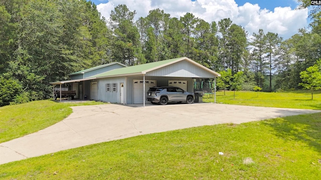 5404 Fairview Rd, Batesburg, SC 29006 - view of front of home with an attached garage, a front lawn, a carport, view of scattered trees, and concrete driveway