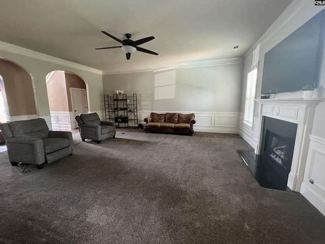 127 Brooklet Dr, Lexington, SC 29072 - living room featuring carpet, a ceiling fan, arched walkways, ornamental molding, and a decorative wall
